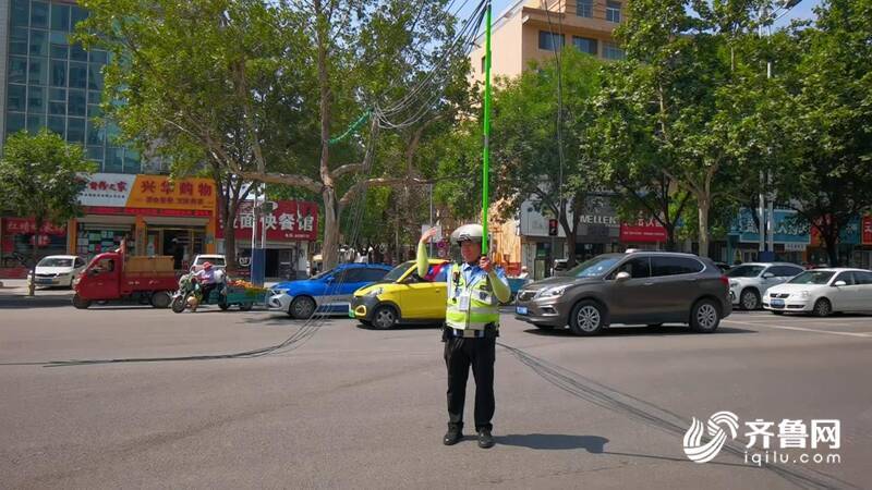 开云体育 开云官网线缆垂落路中央变“拦路虎”！聊城交警40℃高温下托举近两小时(图2)